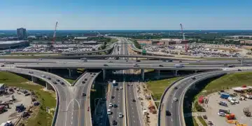 Modern highway interchange under construction, symbolizing the Biden infrastructure plan's progress and economic impact.