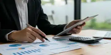 Thoughtful person analyzing financial documents about CARES Act retirement withdrawals and 2026 tax implications.